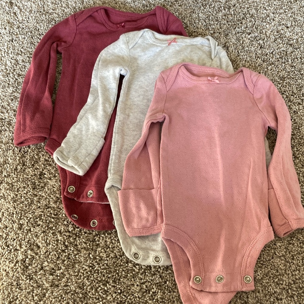 Set of three long-sleeved newborn Carter’s onesies